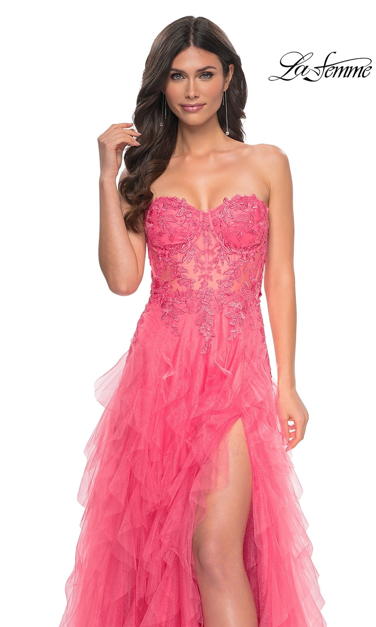 A woman models the La Femme Strapless Long Coral Prom Dress 32286, featuring a beaded-lace bodice, tulle skirt, and high slit, against a white background with the “La Femme” logo in the top right corner.